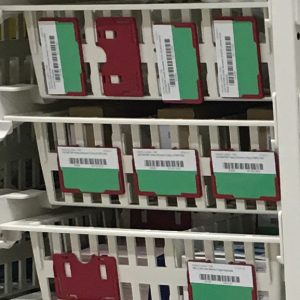 Label holder for high density trays and baskets